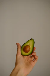Illustration of a woman holding an avocado, styled as the blog’s logo.