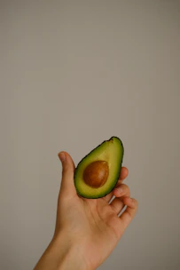 Illustration of a woman holding an avocado, styled as the blog’s logo.