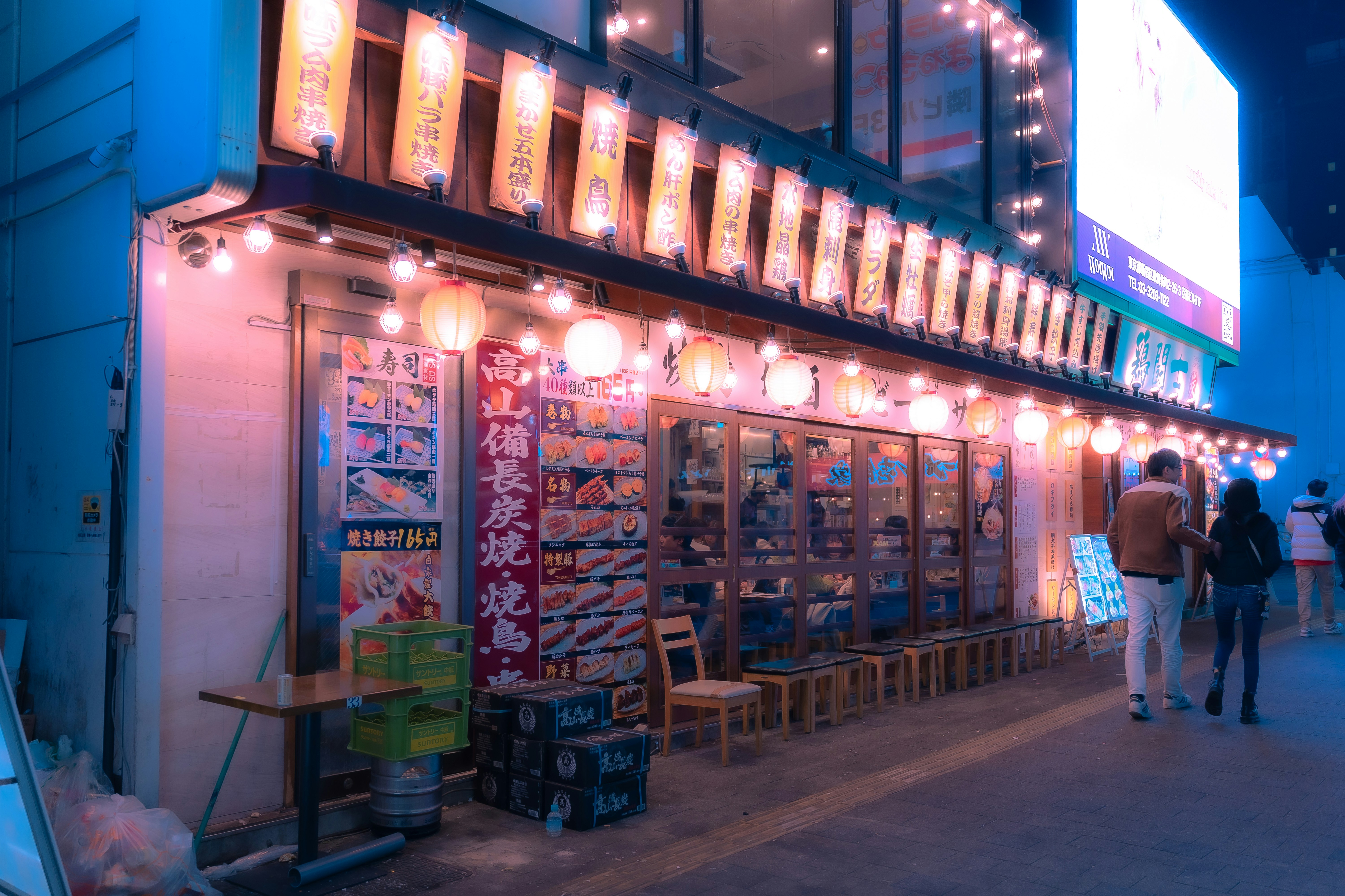 a building with a lot of lights hanging from it's side