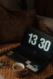 A cozy home setup showing a laptop connected to fast broadband with a cup of coffee nearby.