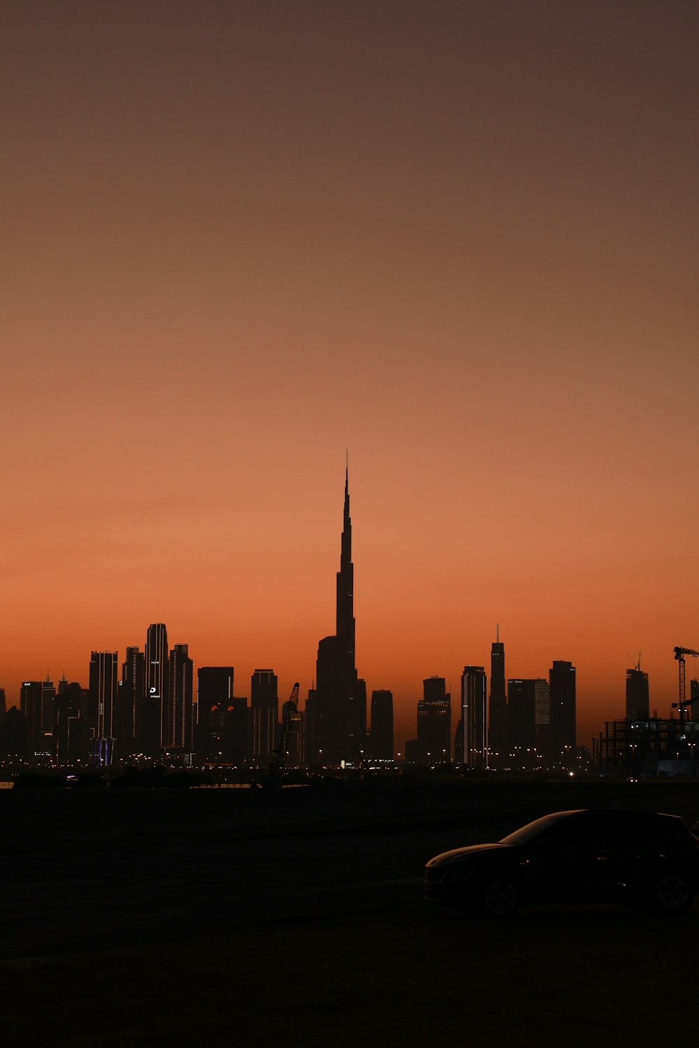 a car is parked in front of a city skyline