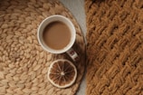 Quiet morning scene with a cup of coffee and crochet placemat on an off-white table.