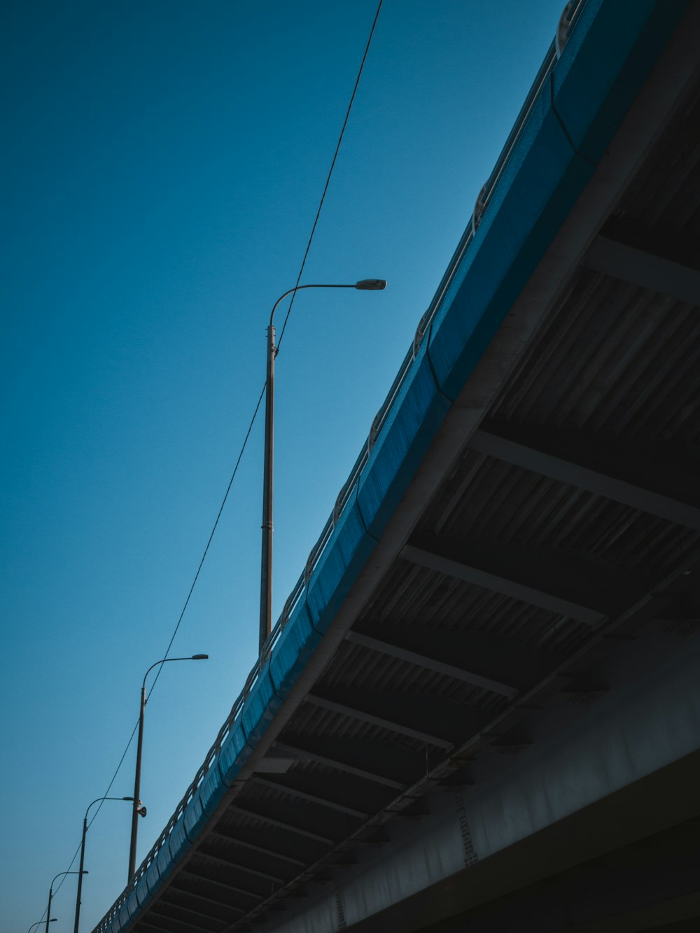 a street light on a pole next to a bridge