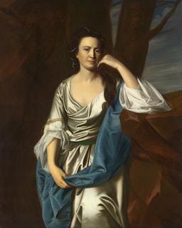 An elegant portrait of a woman in a flowing dress.