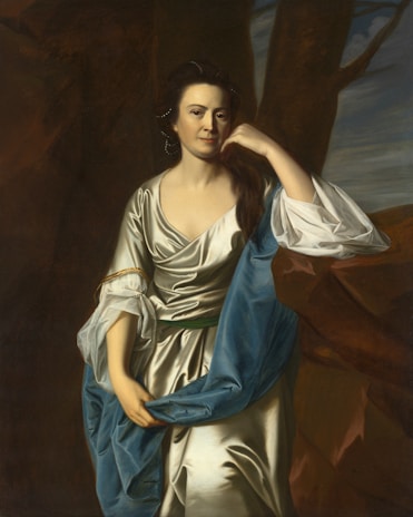 An elegant portrait of a woman in a flowing dress.