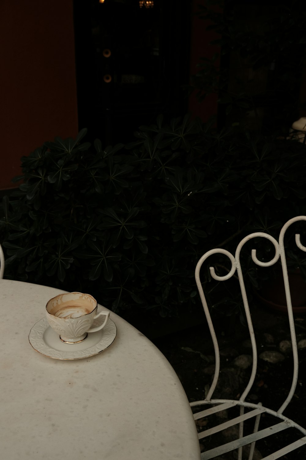 a white table with a cup of coffee on top of it