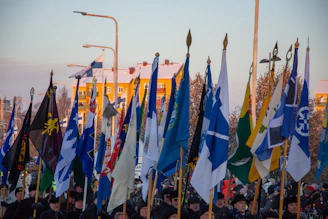 A diverse group of people from various countries holding flags, symbolizing global partnership.