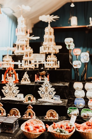 Carved wooden Erzgebirge figurines arranged on a shelf with soft lighting.