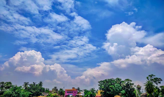 A vibrant Minecraft landscape showing players building together under a bright sky.