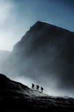a group of people walking up a hill