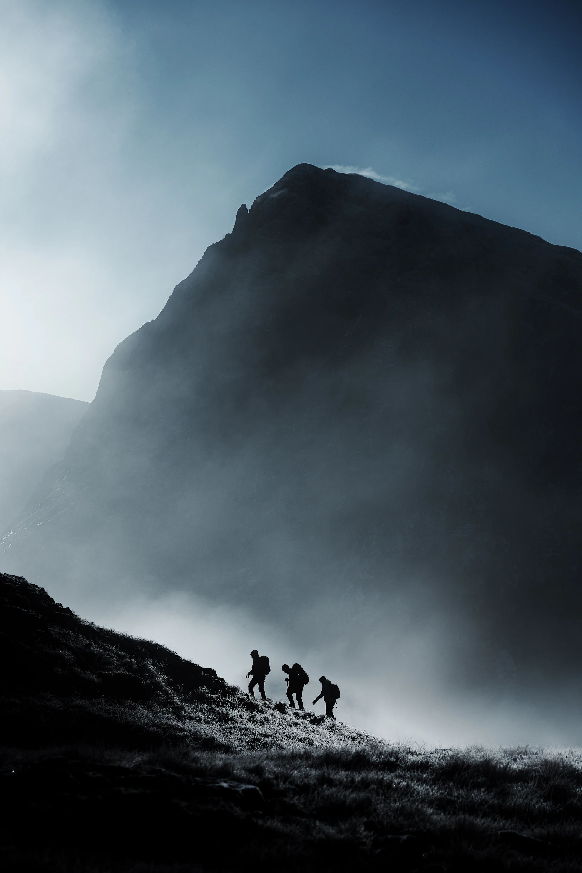 a group of people walking up a hill