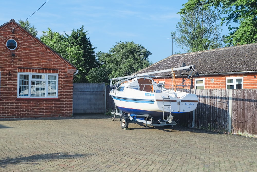 a boat is parked in front of a house