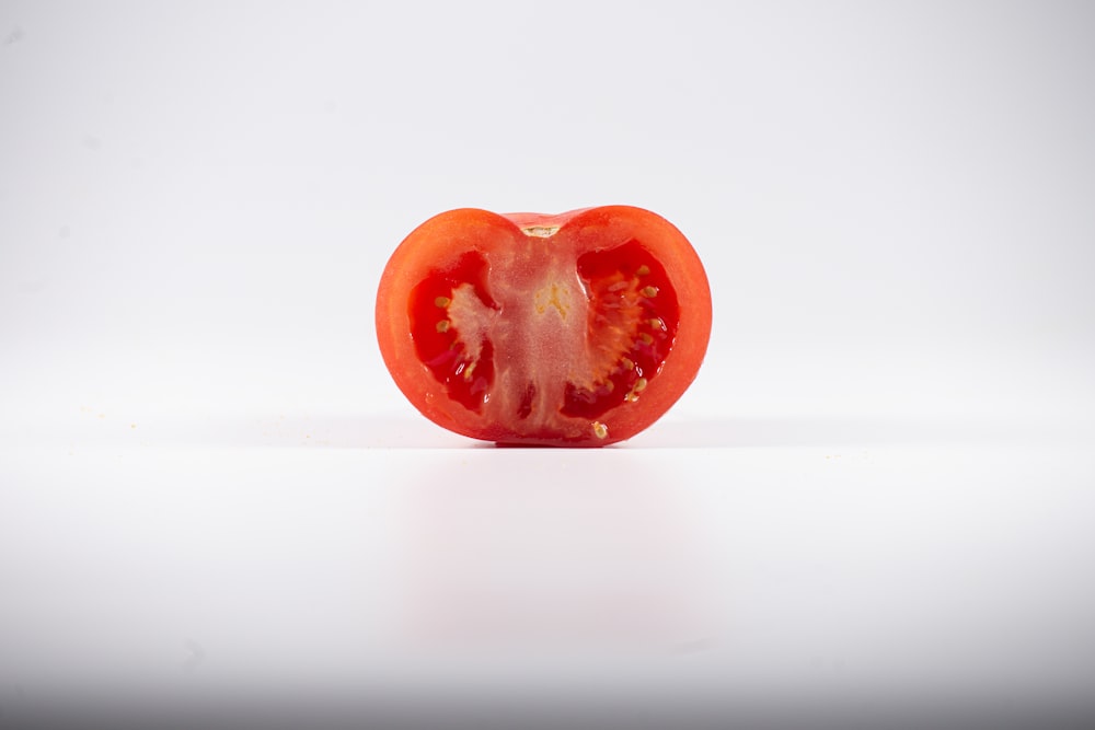 a half of a tomato on a white background