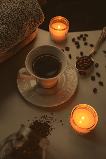 A cozy coffee setup featuring a steaming cup of coffee on a wooden table.
