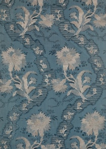 a blue background with white flowers and leaves