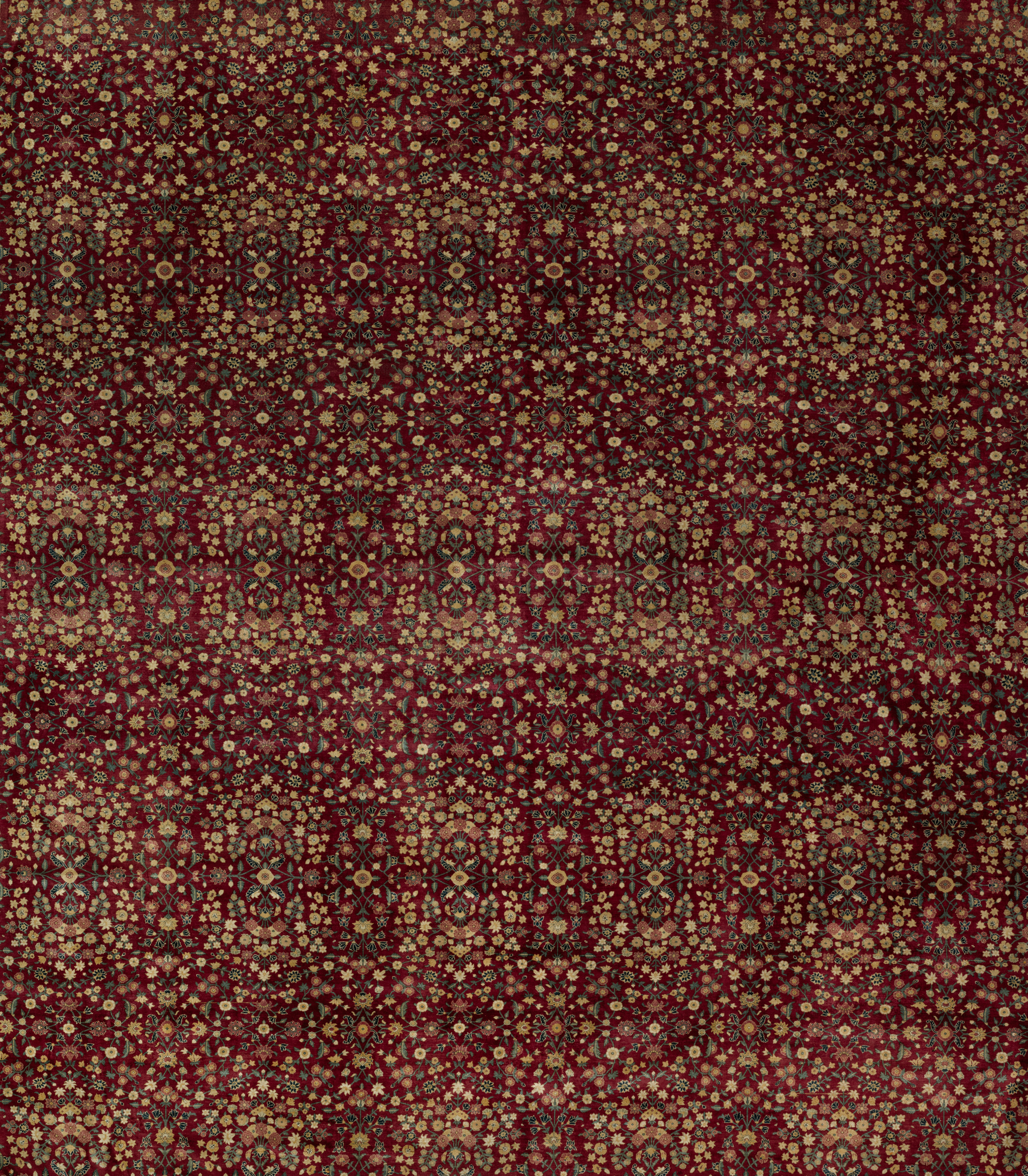 a red and gold rug with a pattern on it