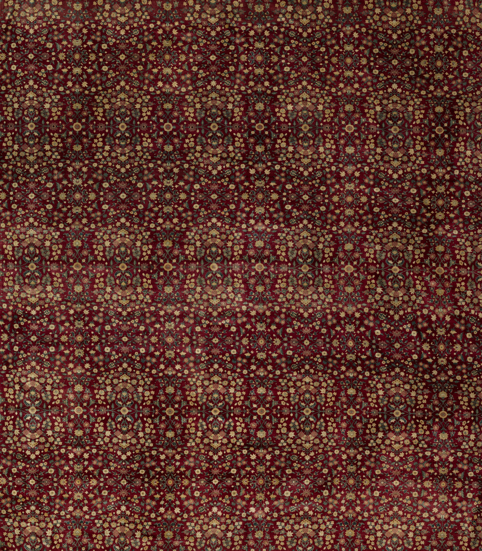 a red and gold rug with a pattern on it