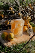 A close-up of a glass of quince aperitif with a slice of quince.