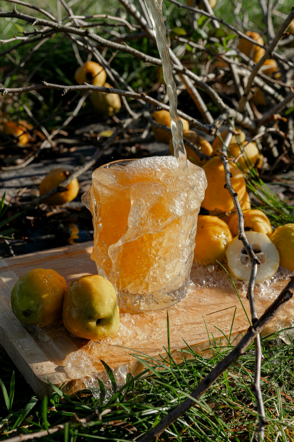 a wooden cutting board topped with fruit and ice