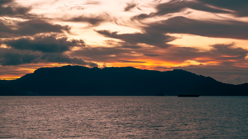 a large body of water under a cloudy sky