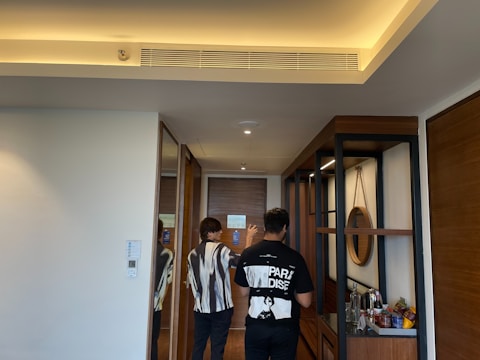 Person guiding a couple through a new apartment showing features.