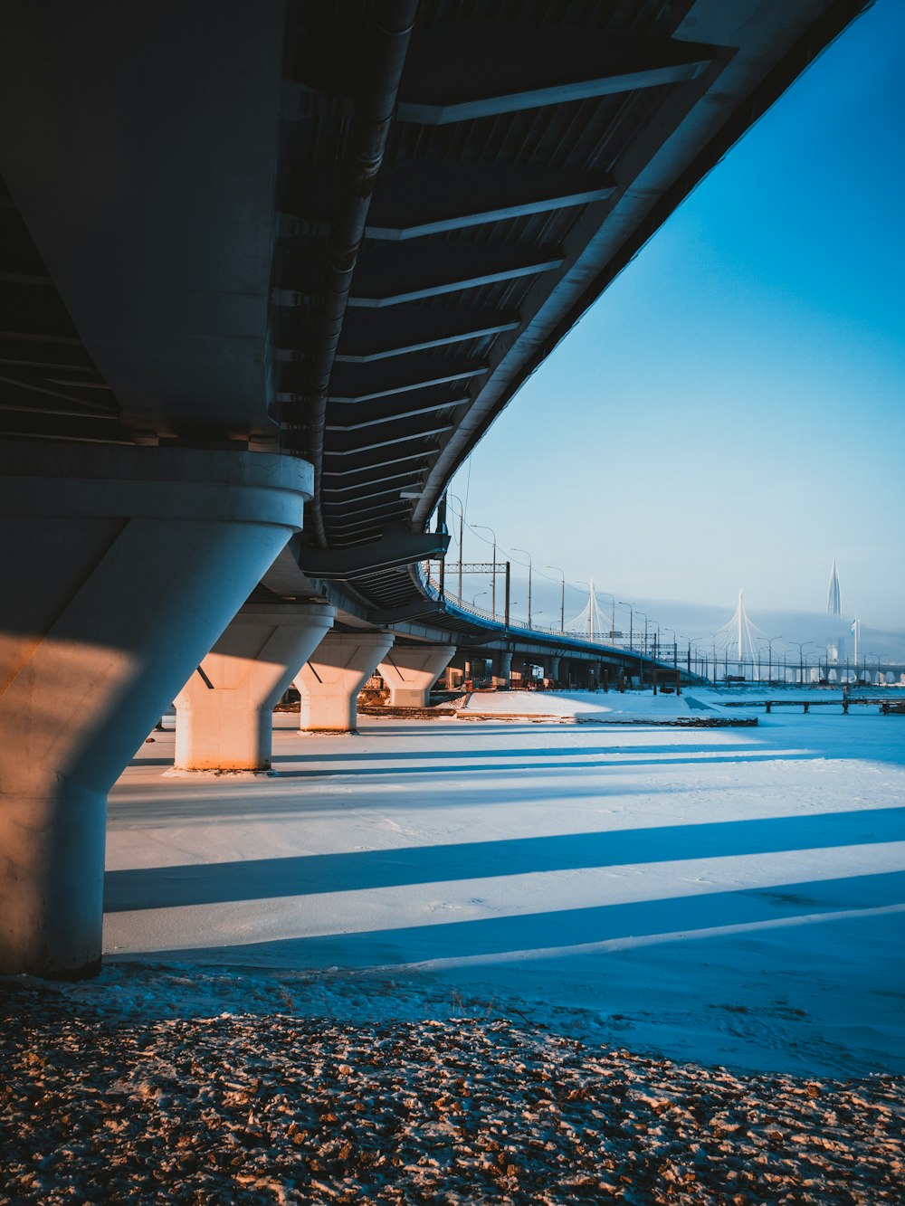 the underside of a bridge over a body of water