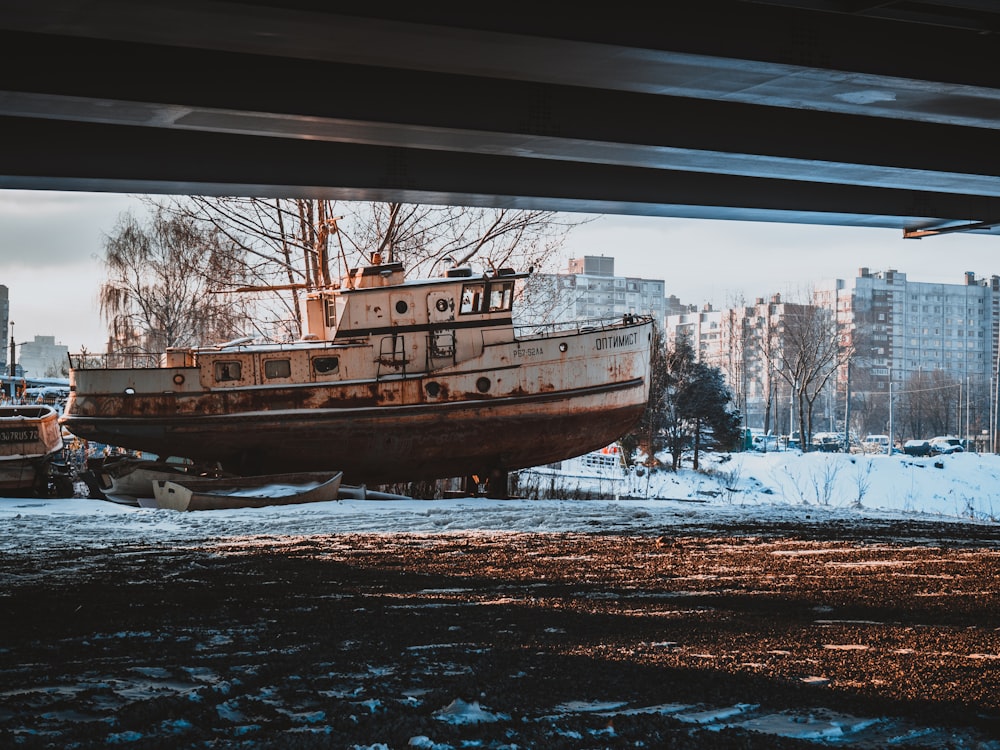 a large boat sitting on top of snow covered ground