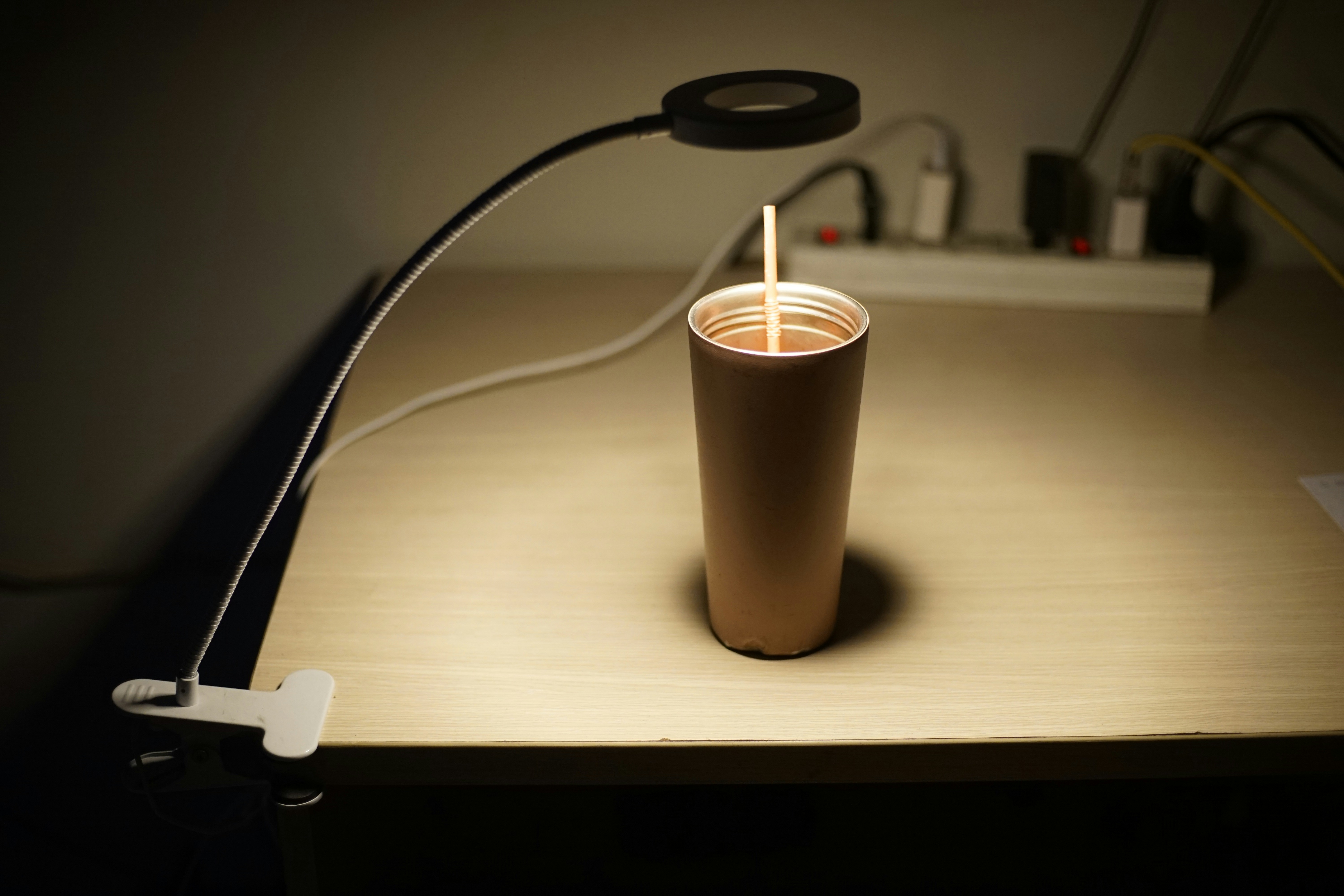 6 Easy Ways to Burn Calories While Sitting at Your Desk – a cup with a straw in it sitting on a table