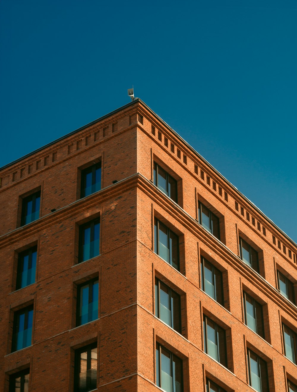 a tall brick building with lots of windows