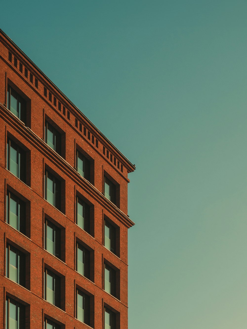 a red brick building with a clock on the top of it