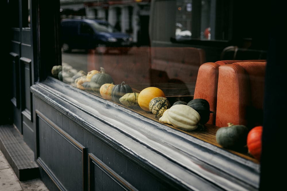 a window with a bunch of different types of gourds