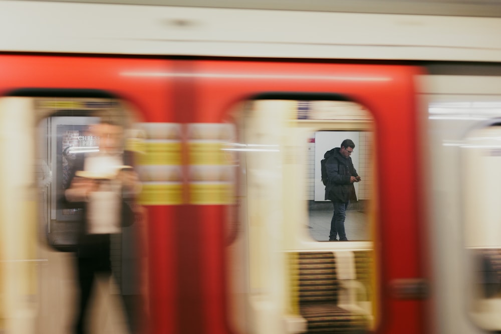 a blurry photo of people standing on a train platform