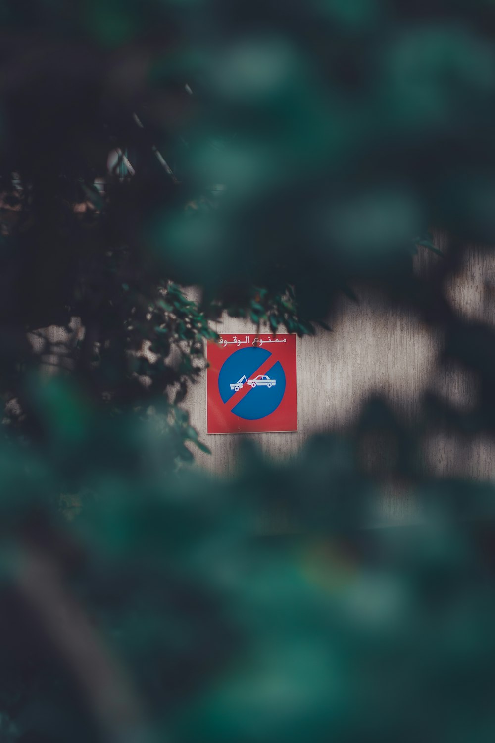 a red and blue sign hanging on a wall