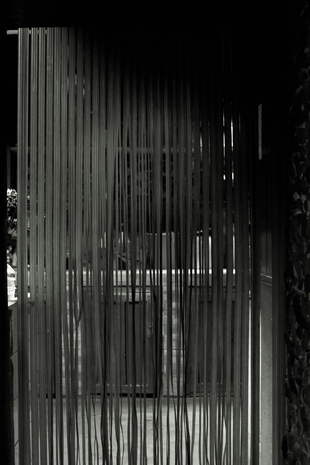 a black and white photo of a room with curtains