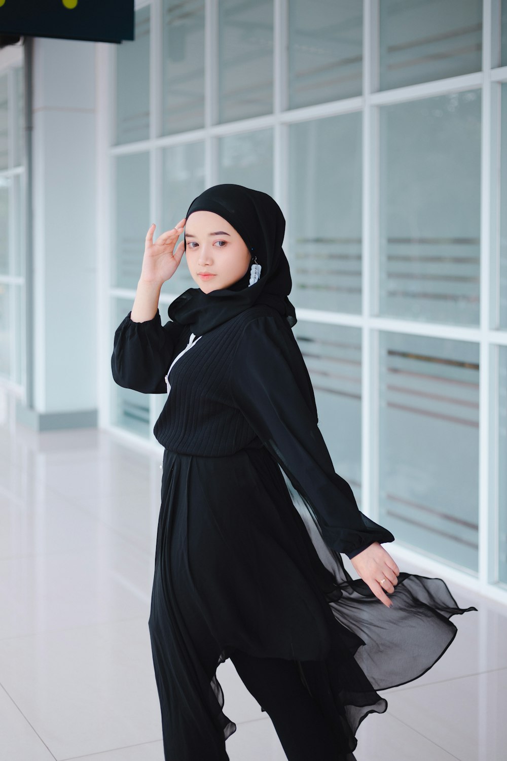 a woman in a hijab poses for a picture
