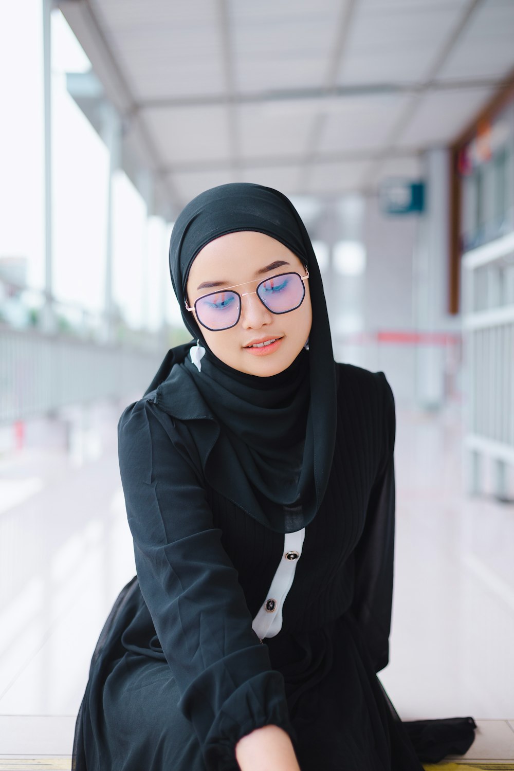 a woman in a hijab sitting on the ground