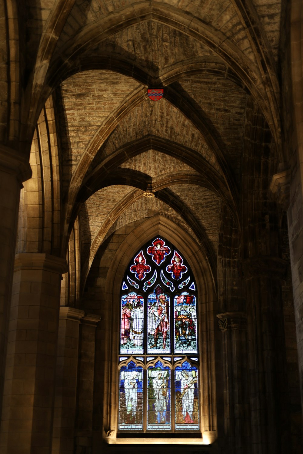 a large stained glass window in a stone building