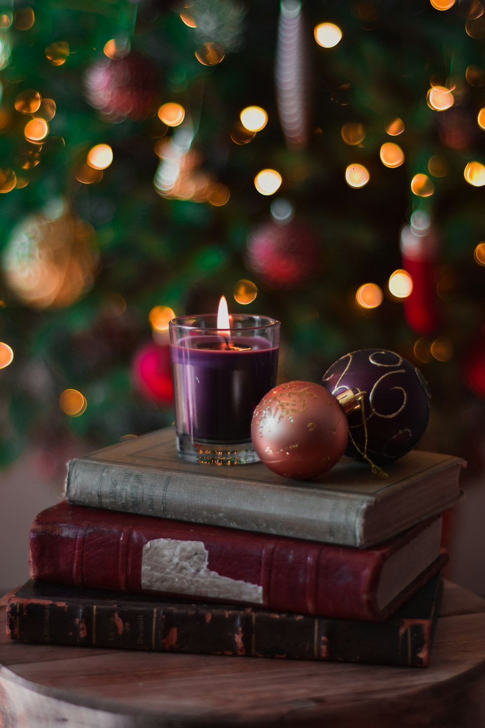 a candle sitting on top of a stack of books