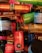 A collection of various hair styling products from the brand Redken, including thermal sprays, pliable paste, and other haircare items in a variety of colorful packaging such as red, orange, blue, and green bottles and jars.