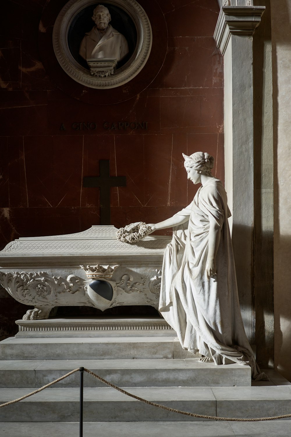 a statue of a woman holding a casket