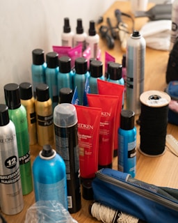 a table topped with lots of different types of hair products