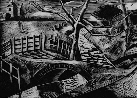 A black and white linocut-style artwork depicting a landscape with a bridge over a stream or river. In the background, there are houses with pitched roofs and several bare trees. A solitary figure walks along the pathway leading to the bridge, framed by a wooden fence.