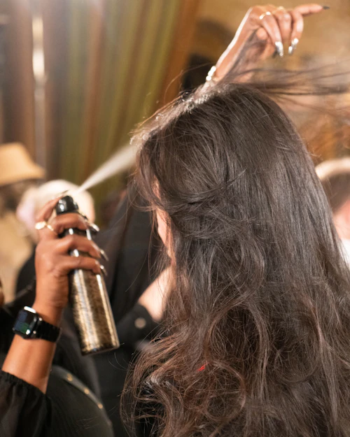 Stylist blow drying a client's hair
