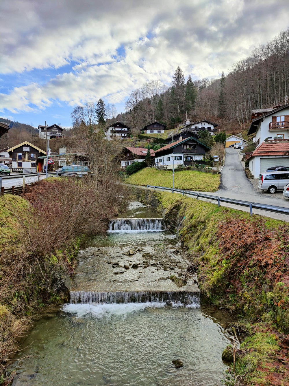 a stream running through a lush green hillside