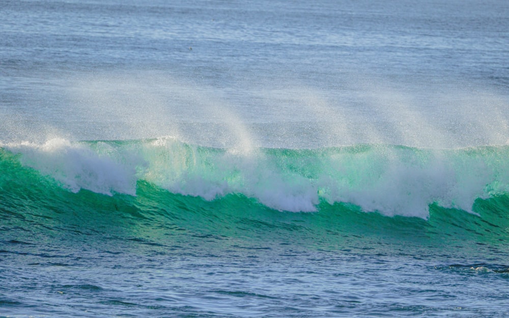 a man riding a wave on top of a surfboard