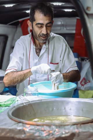 A chef preparing food in a mobile kitchen.