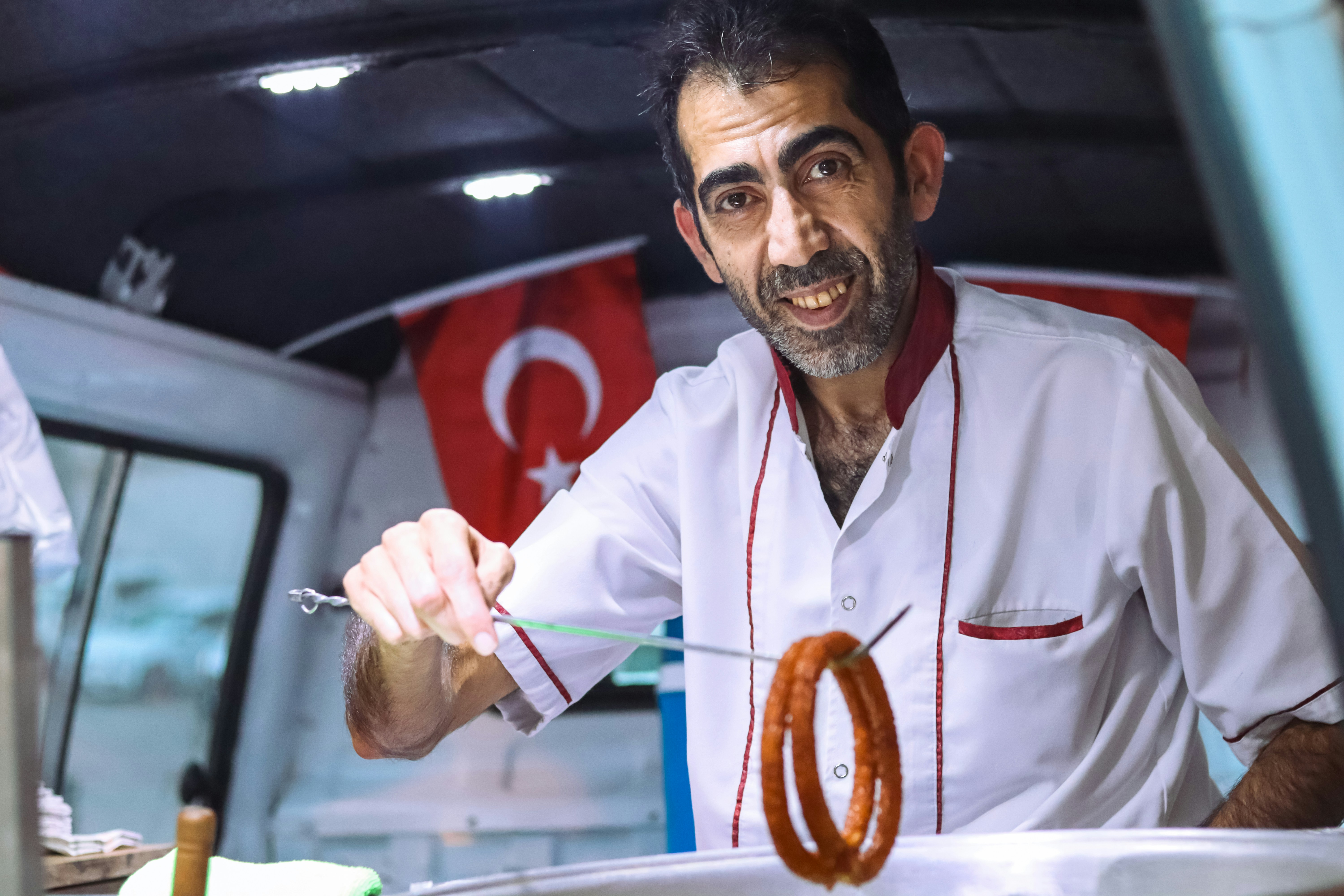 a man in a white shirt is holding a fork