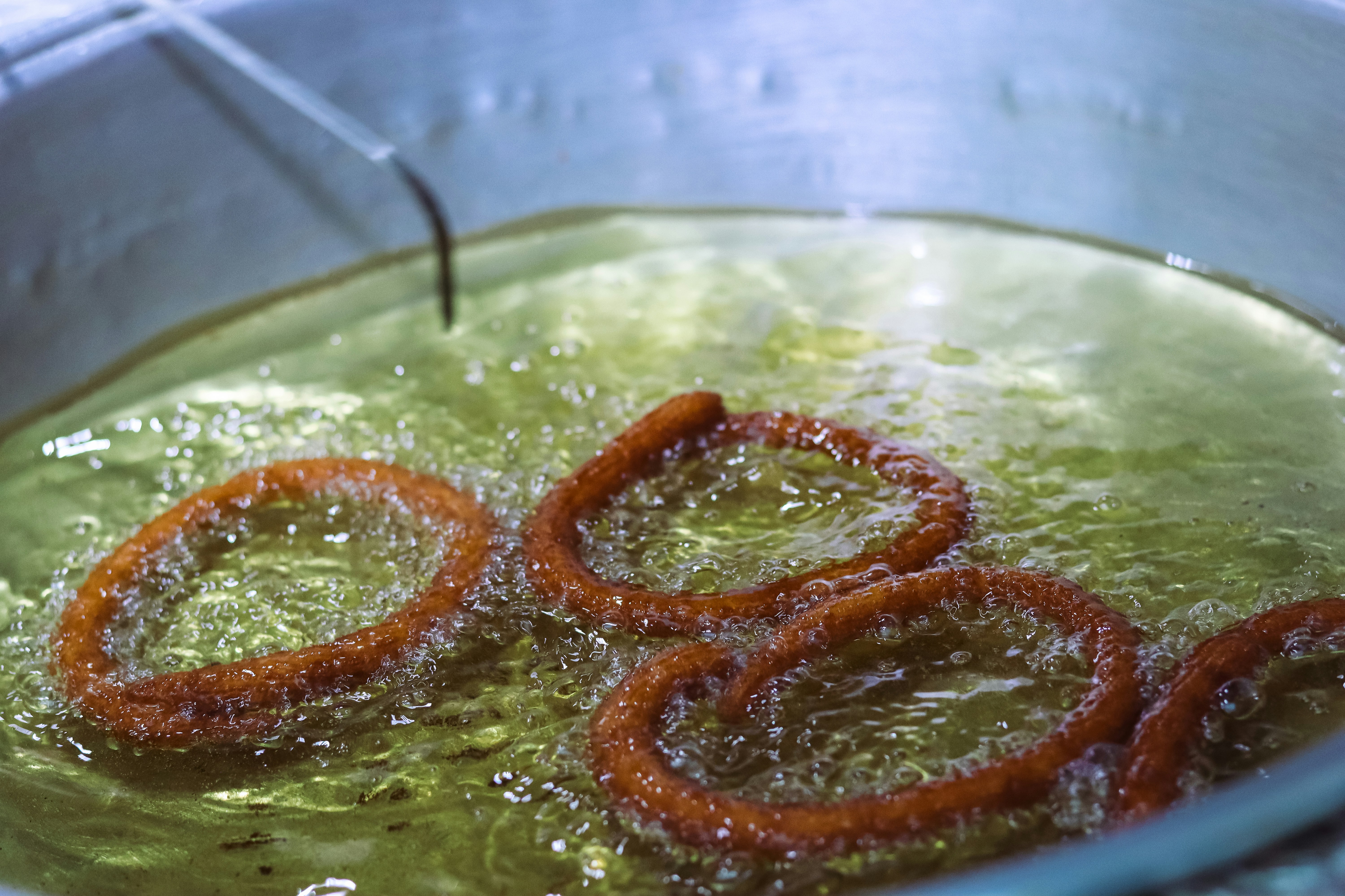 Churro rings frying in oil