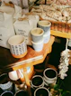 a wooden table topped with lots of cups