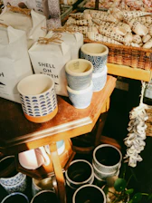 a wooden table topped with lots of cups